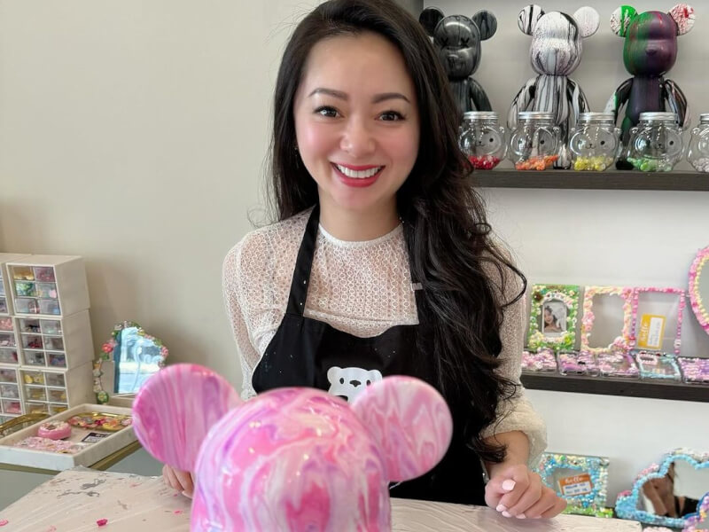 Woman smiling with fluid bear she made